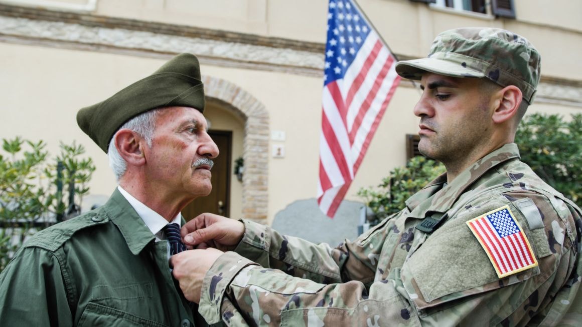 Military officers in uniform with American flag