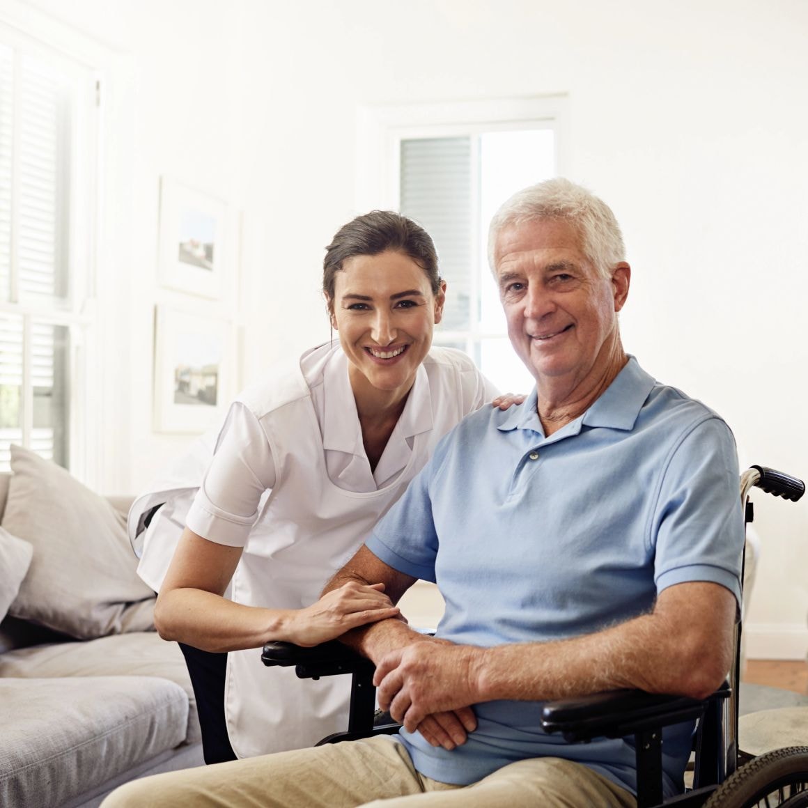 Caregiver smiling with elderly veteran patient